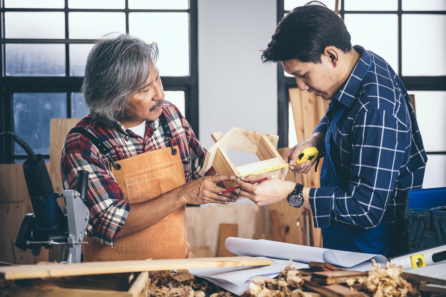 two carpenters working in shop wood craftsman 9j93qpf.jpg